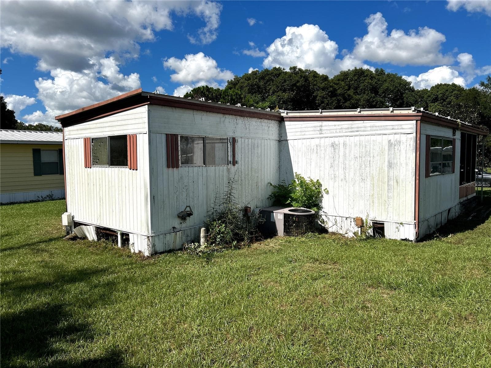 other view of back of home facing primary bedroom, AC unit and living room. - 14506 DEHAVEN AVE, BROOKSVILLE