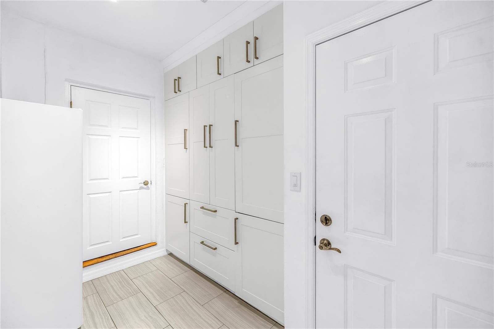 Custom cabinetry featuring ample storage solutions for laundry detergents, bulk household inventory, and utility organization. - 146 GIRALDA BLVD NE, ST PETERSBURG