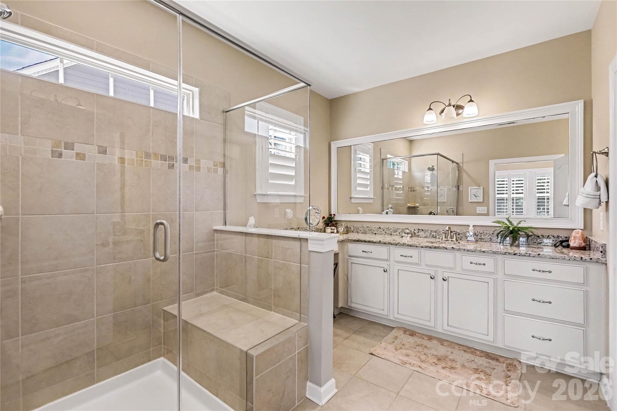 Primary bathroom has a large shower, separate vanities, and a private water closet. - 1567 Tranquility Boulevard, Lancaster