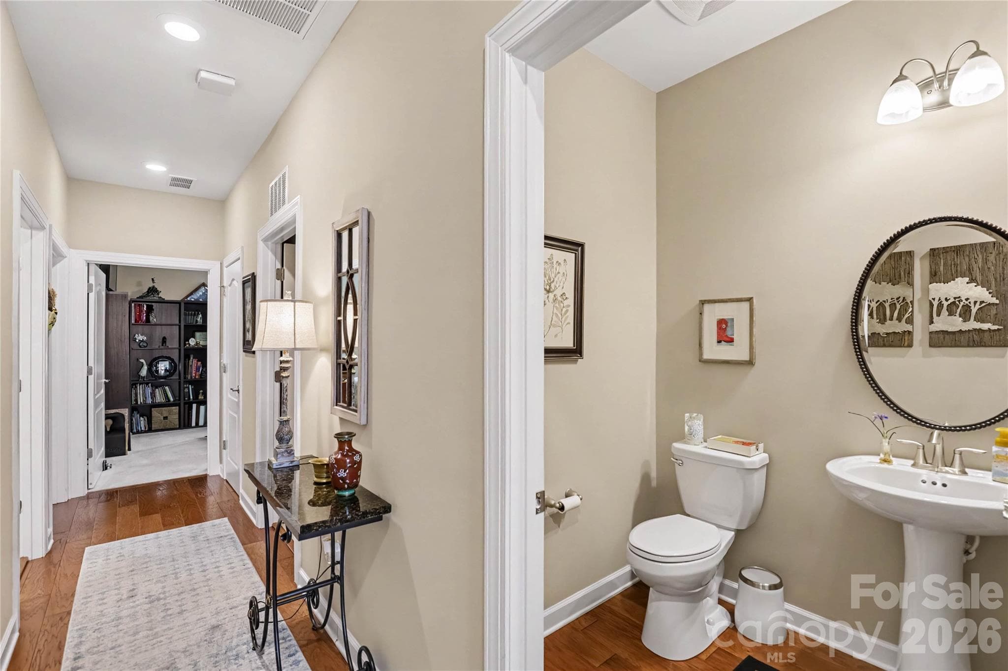 Hallway to bedrooms 2 & 3, a second full bathroom, a powder room, and a laundry room - 1567 Tranquility Boulevard, Lancaster