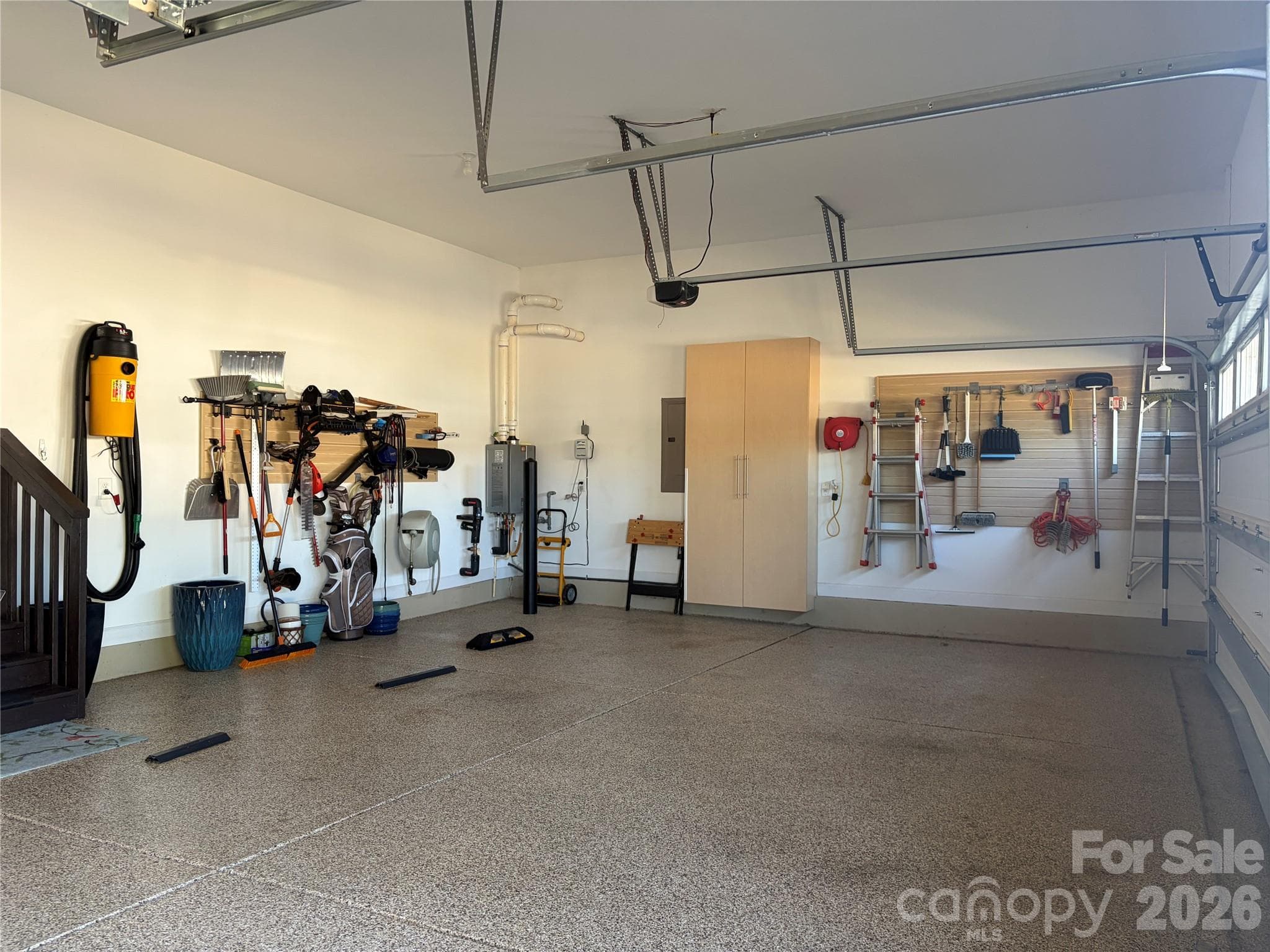3-car garage with epoxy floors and storage cabinets - 1567 Tranquility Boulevard, Lancaster