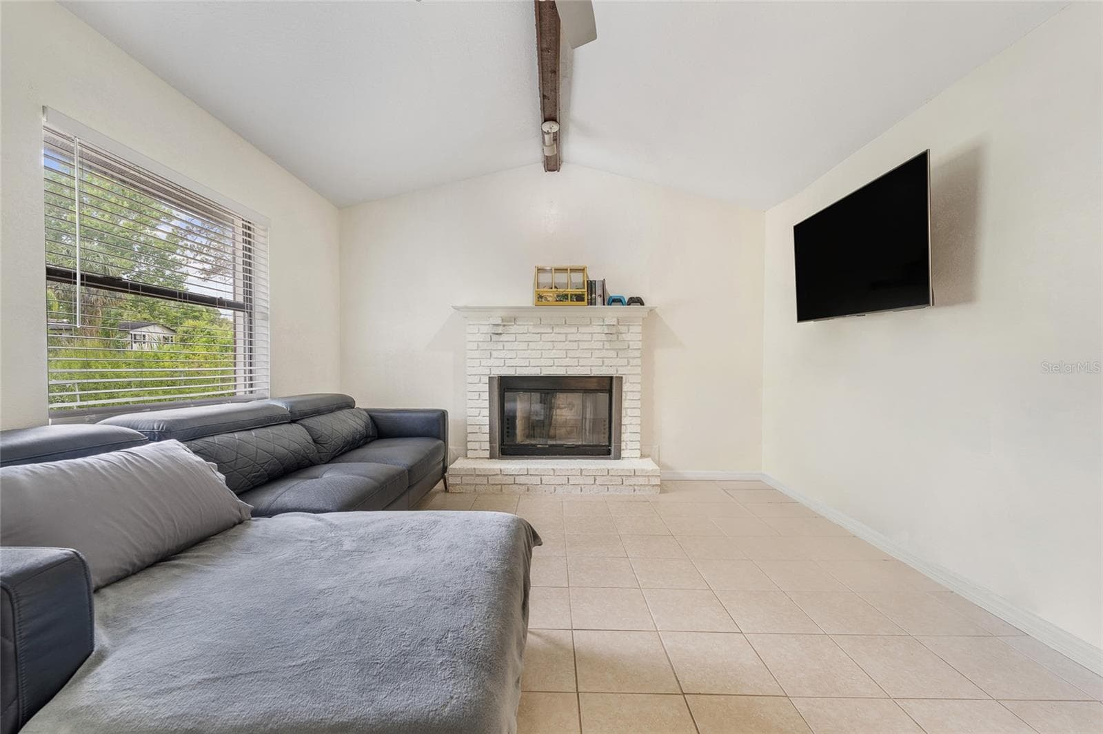 View of fire place with large window offering natural light. - 2040 E TRIANGLE DR, LONGWOOD