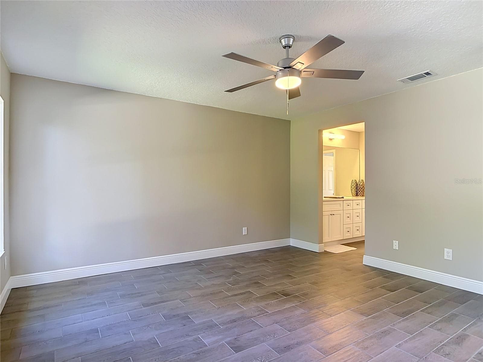 Primary bedroom. - 3025 FOXBORO CIR, DELTONA