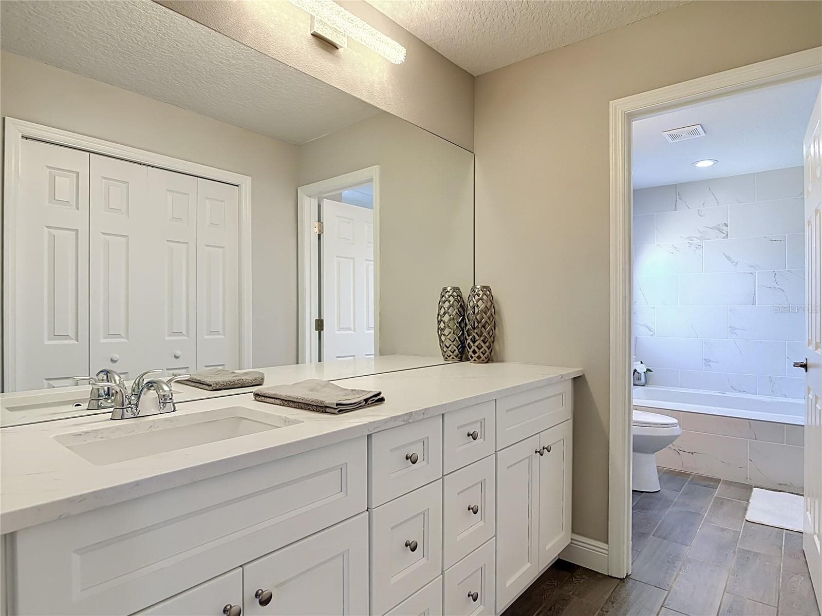 Primary bathroom with separate vanities. - 3025 FOXBORO CIR, DELTONA