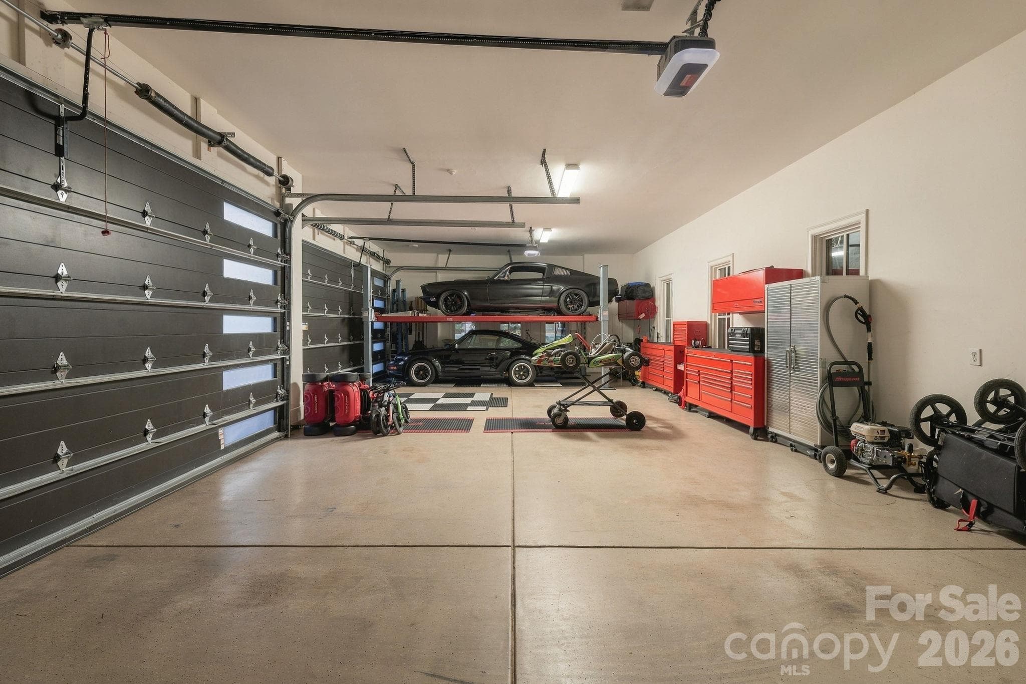 This 4-car garage has a lift in one of the bays, so room for 5 cars! - 21215 Senlac Lane, Cornelius