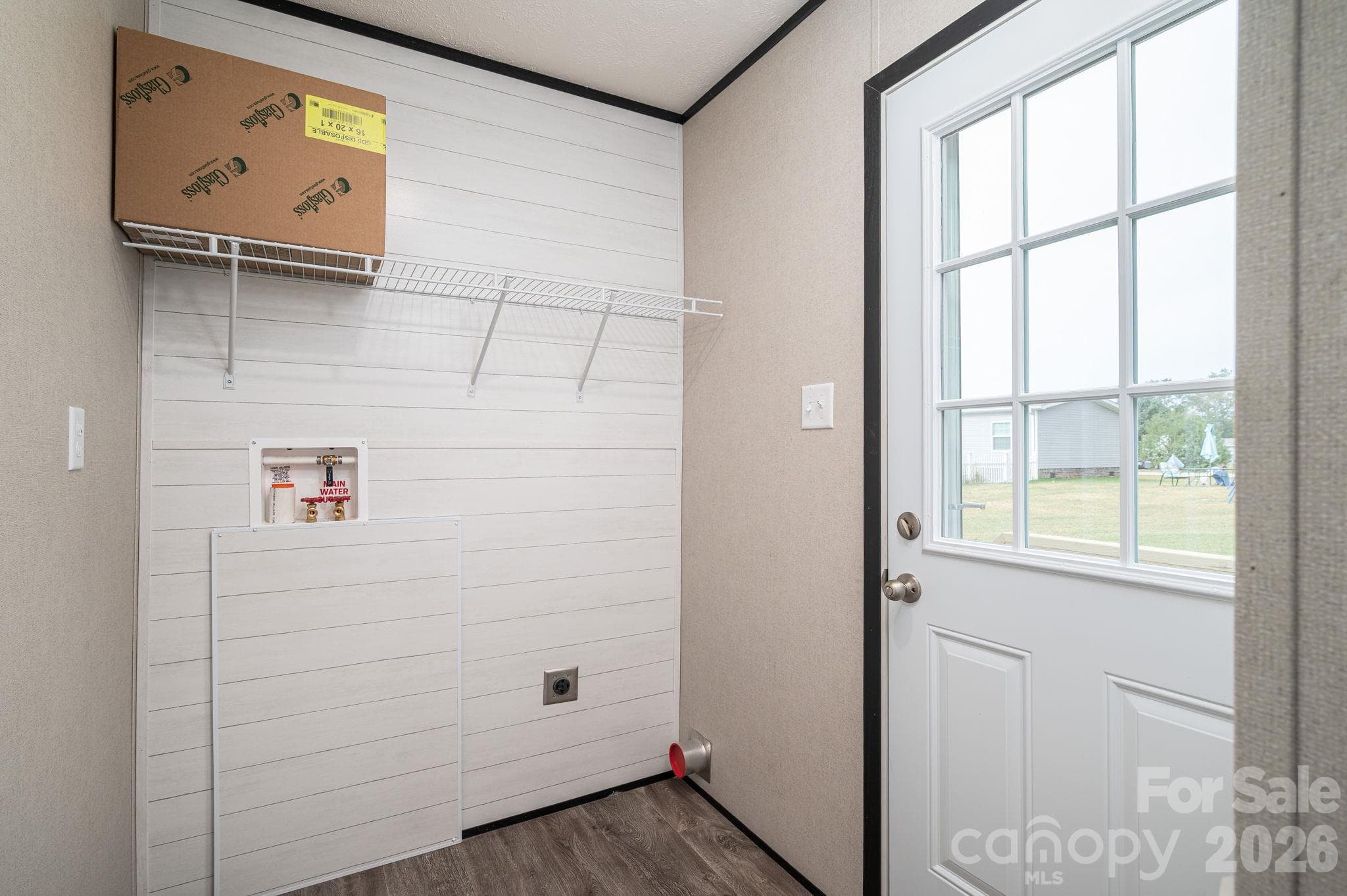 Laundry Room with shelving and accent shiplap wall - 207 Grassy Field Court, Lawndale