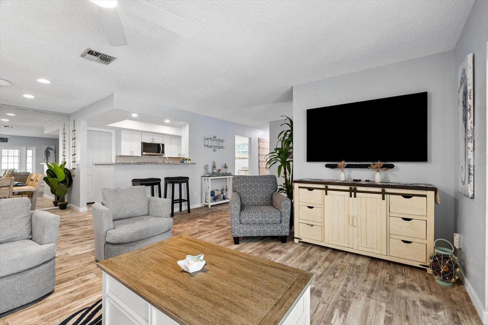 Open concept living room facing kitchen and dining room - 1307 STONEHAVEN LN, DUNEDIN