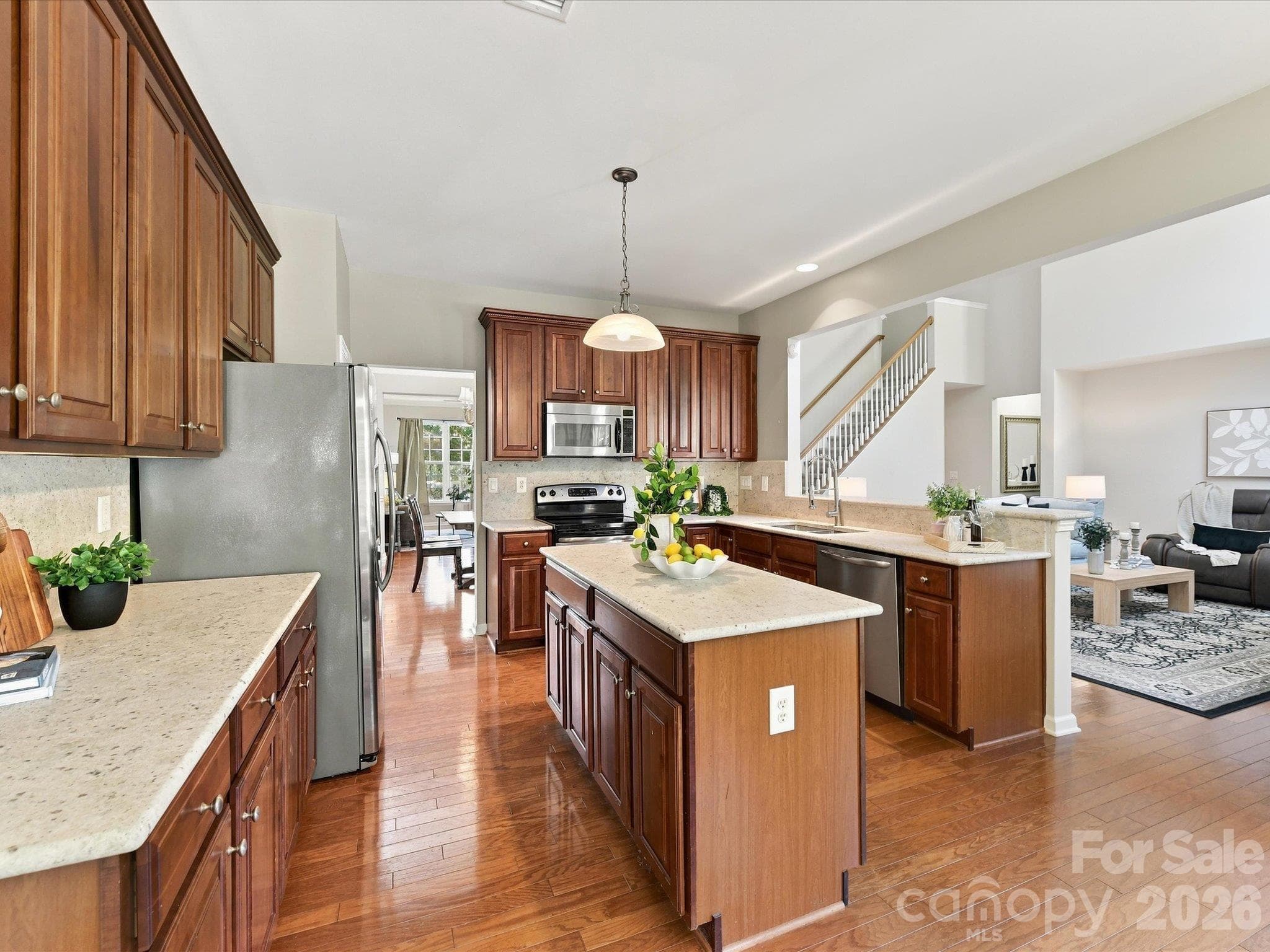 Inviting kitchen with plentiful cabinetry, brand-new gorgeous granite countertops, a center island, stainless steel appliances, and a layout that seamlessly blends style and functionality. - 1788 Oakmont Drive, Denver