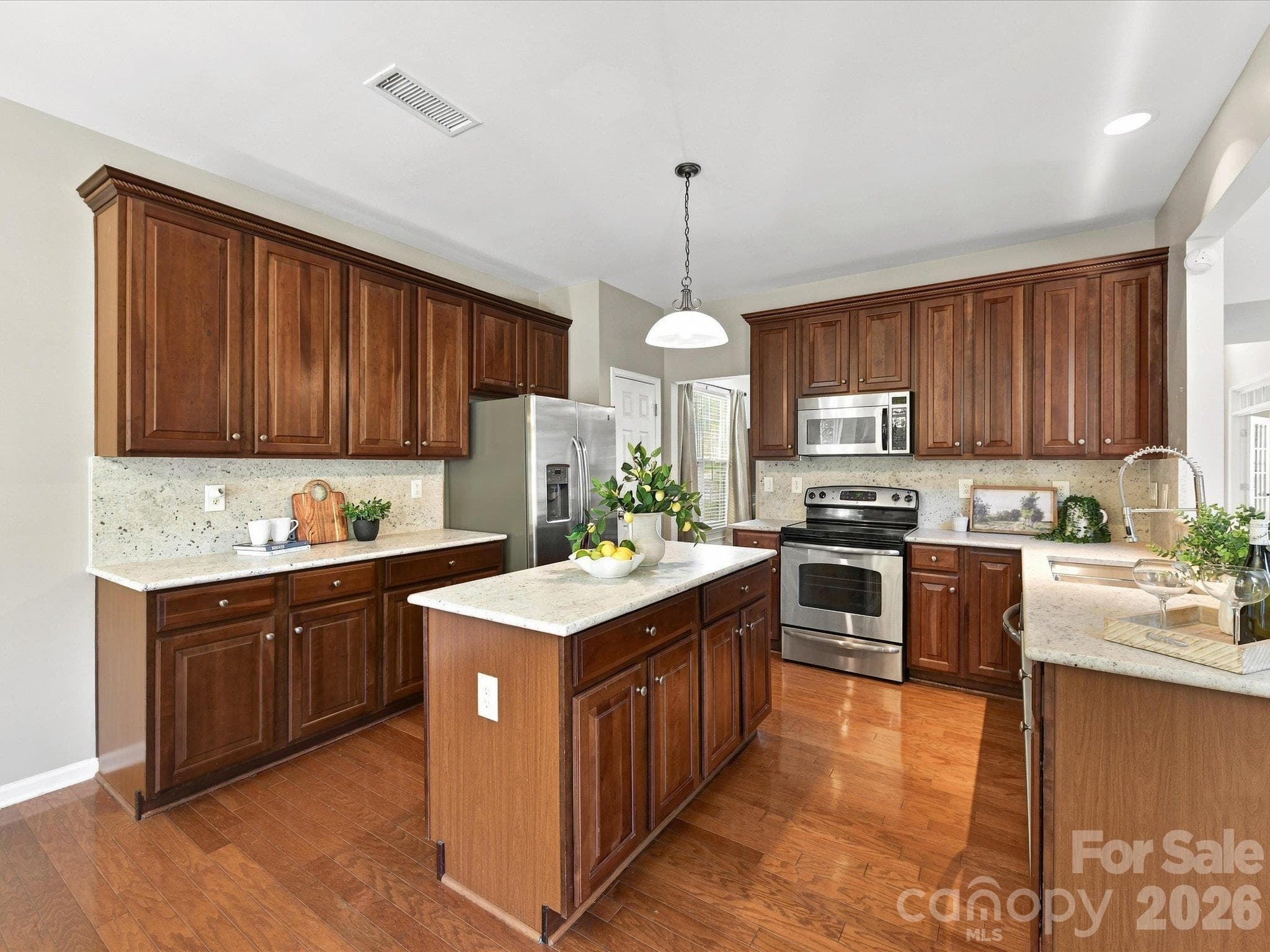 Inviting kitchen with plentiful cabinetry, brand-new gorgeous granite countertops, a center island, stainless steel appliances, and a layout that seamlessly blends style and functionality. - 1788 Oakmont Drive, Denver