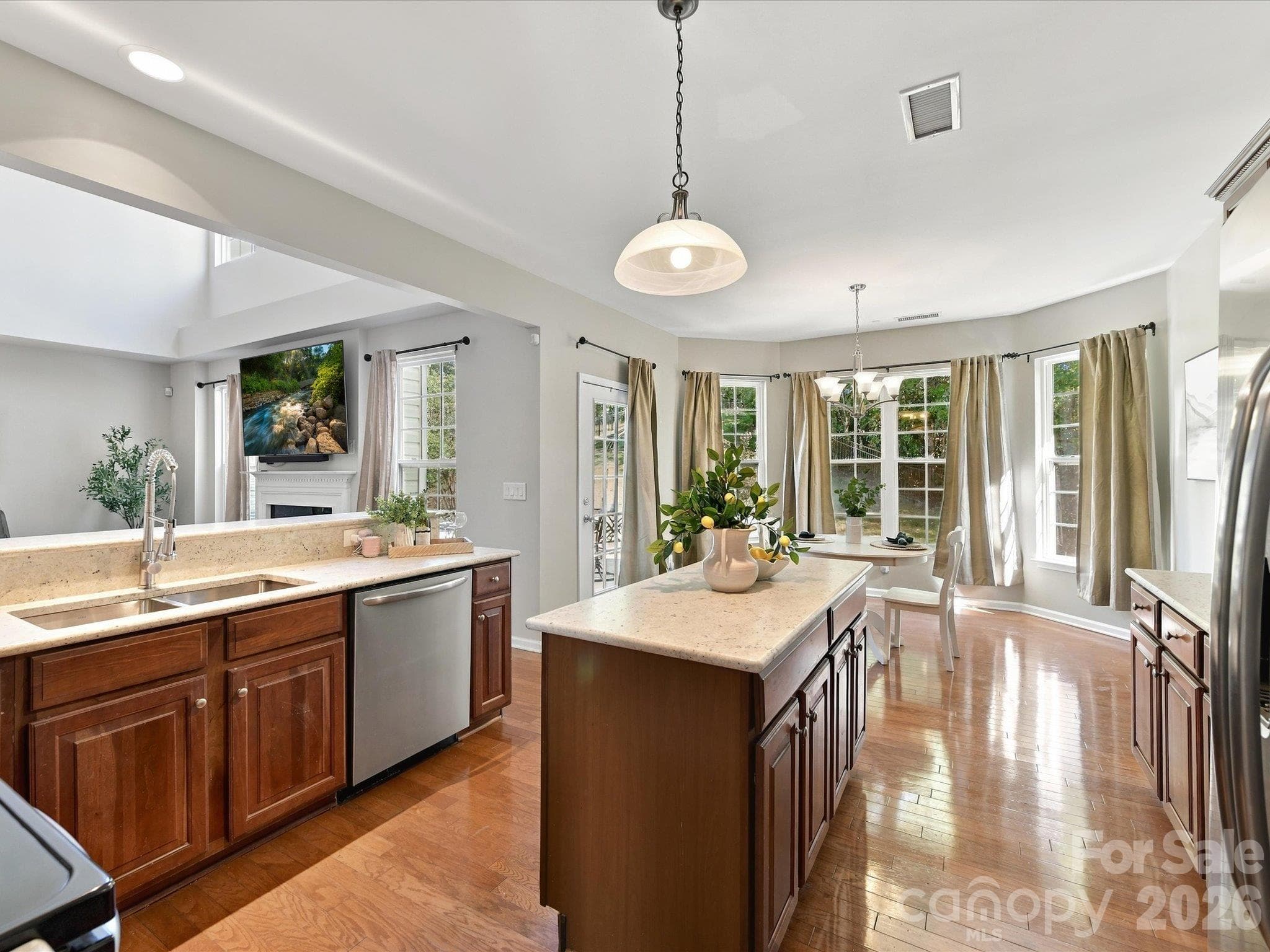 Inviting kitchen with plentiful cabinetry, brand-new gorgeous granite countertops, a center island, stainless steel appliances, and a layout that seamlessly blends style and functionality. - 1788 Oakmont Drive, Denver
