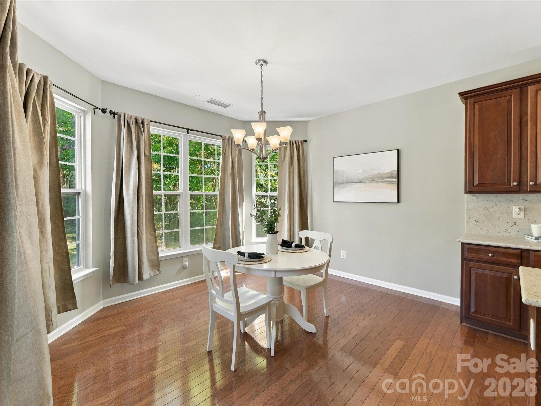 Sun-filled breakfast nook surrounded by large windows, creating the perfect space to enjoy morning coffee, casual meals, and peaceful backyard views. - 1788 Oakmont Drive, Denver