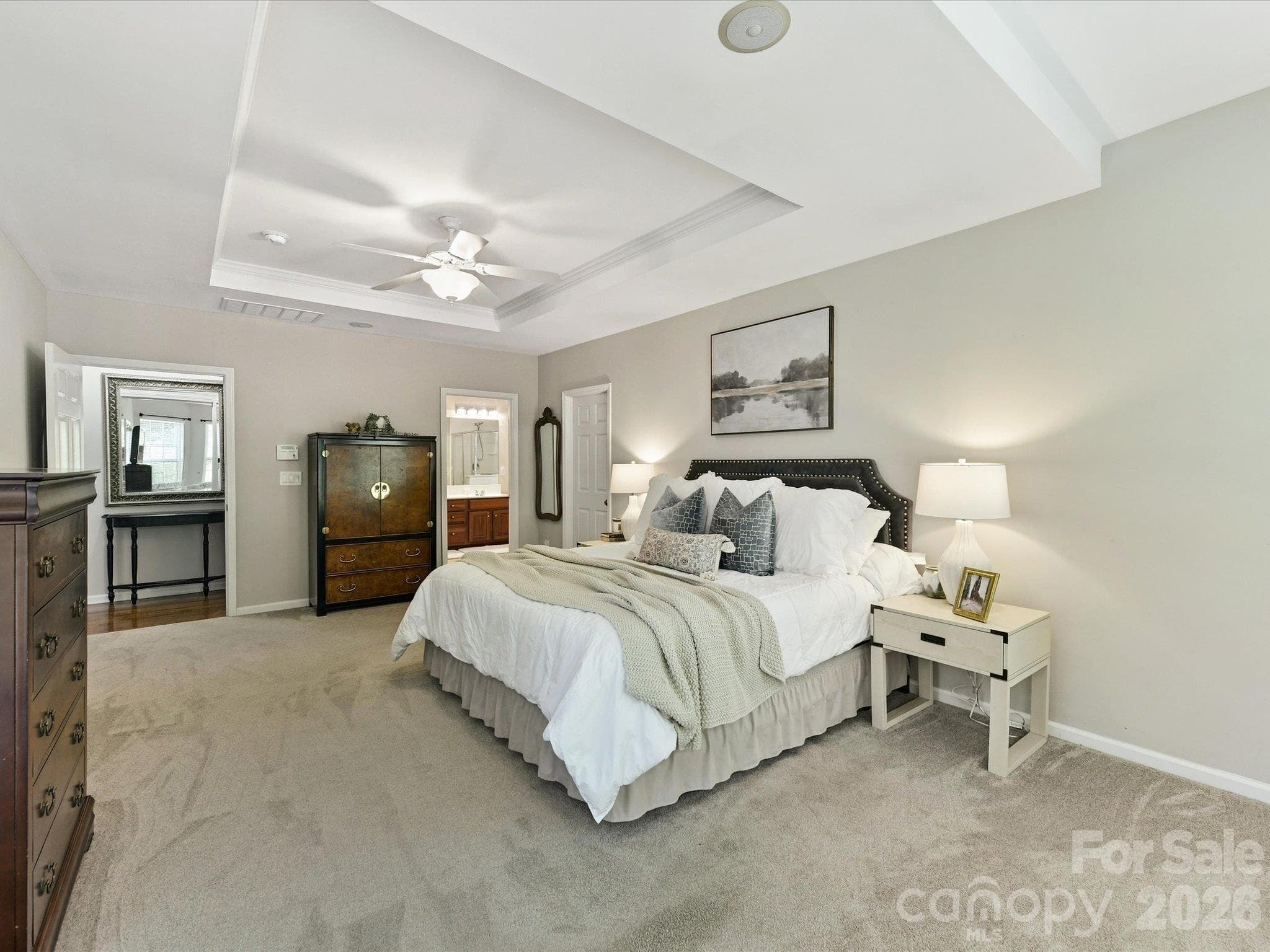Spacious primary suite featuring a tray ceiling, abundant natural light, a cozy sitting area, and plenty of room to create your own private retreat. - 1788 Oakmont Drive, Denver