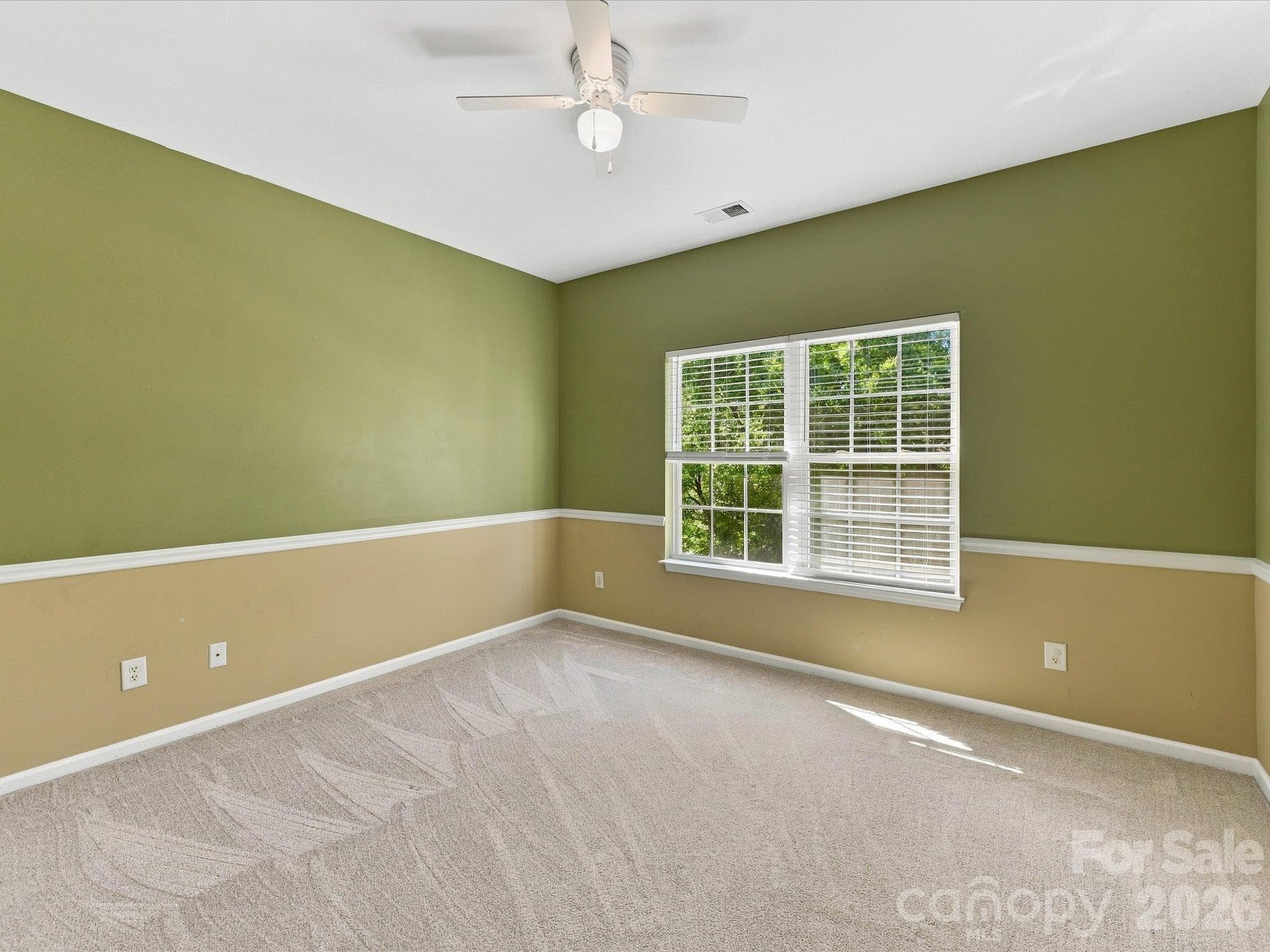 This spacious secondary bedroom offers ample room for furnishings, abundant natural light, and a comfortable layout ideal for family or guests. - 1788 Oakmont Drive, Denver