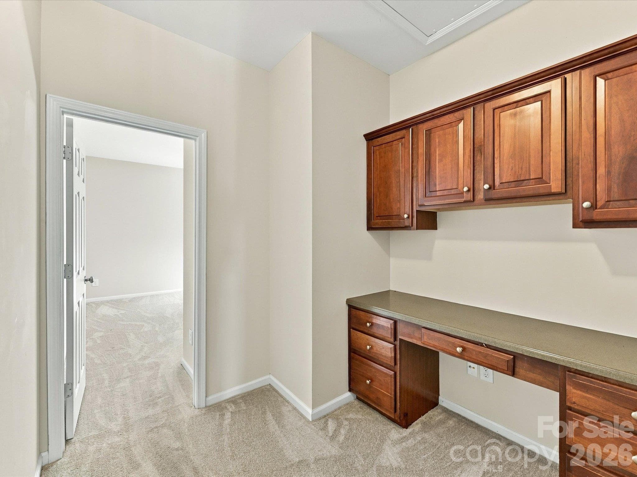 Dedicated built-in workspace with custom cabinetry, generous storage, and a functional desk area—perfect for working from home, studying, or managing daily tasks. - 1788 Oakmont Drive, Denver