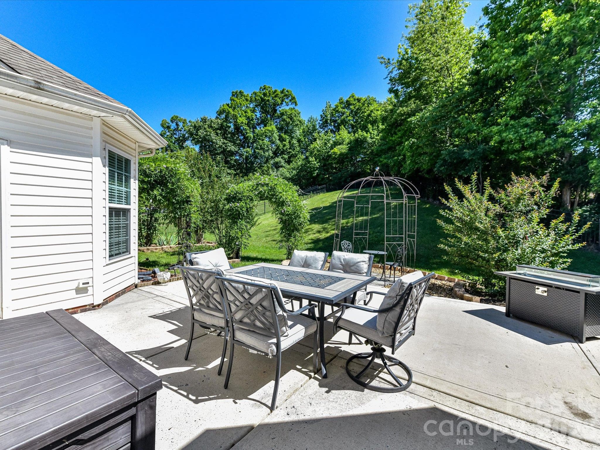 Enjoy seamless indoor-outdoor living with an expansive patio that opens to a beautifully landscaped backyard retreat. - 1788 Oakmont Drive, Denver