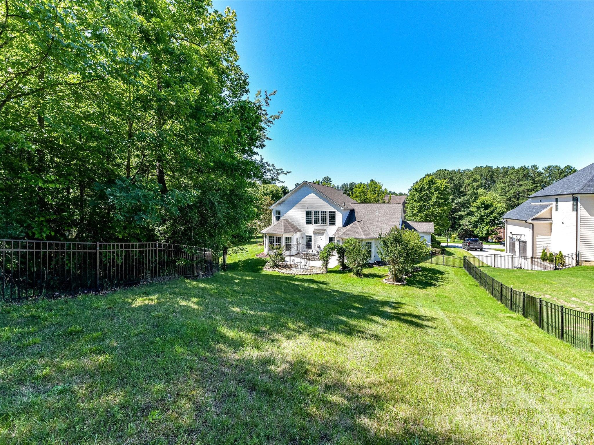 Large backyard offers privacy, mature trees, and plenty of space for recreation, gardening, or future outdoor enhancements. - 1788 Oakmont Drive, Denver