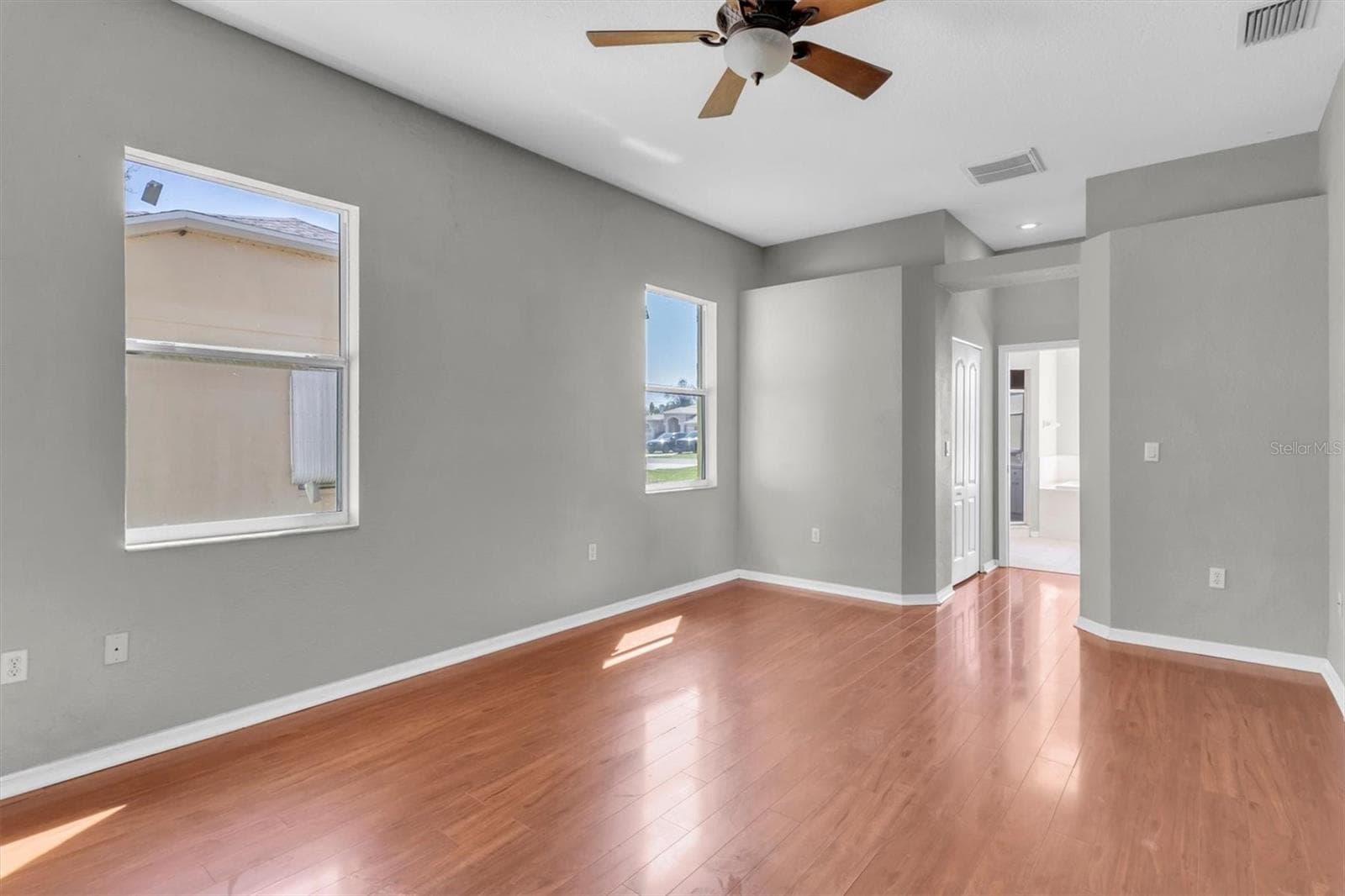 Primary bedroom with hallway leading to the ensuite bathroom - 15433 SONORA DR, BROOKSVILLE