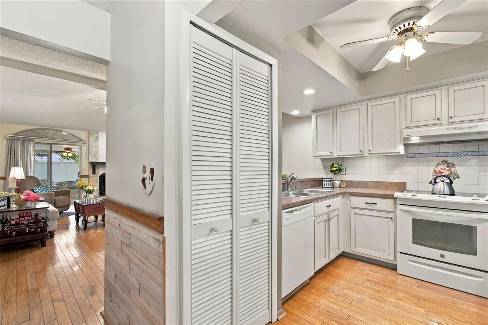 Your foyer opens up to a welcoming custom wood wall paneling as seen in this photo. - 13020 LEVERINGTON ST, TAMPA