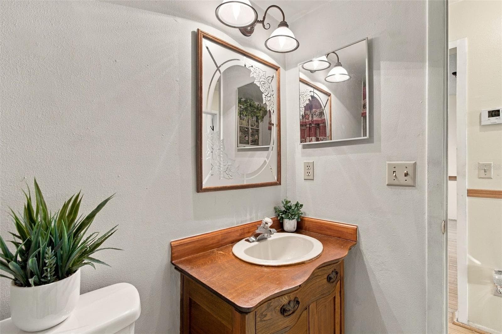 Your secondary bathroom features an antique cabinet that was custom installed. - 13020 LEVERINGTON ST, TAMPA