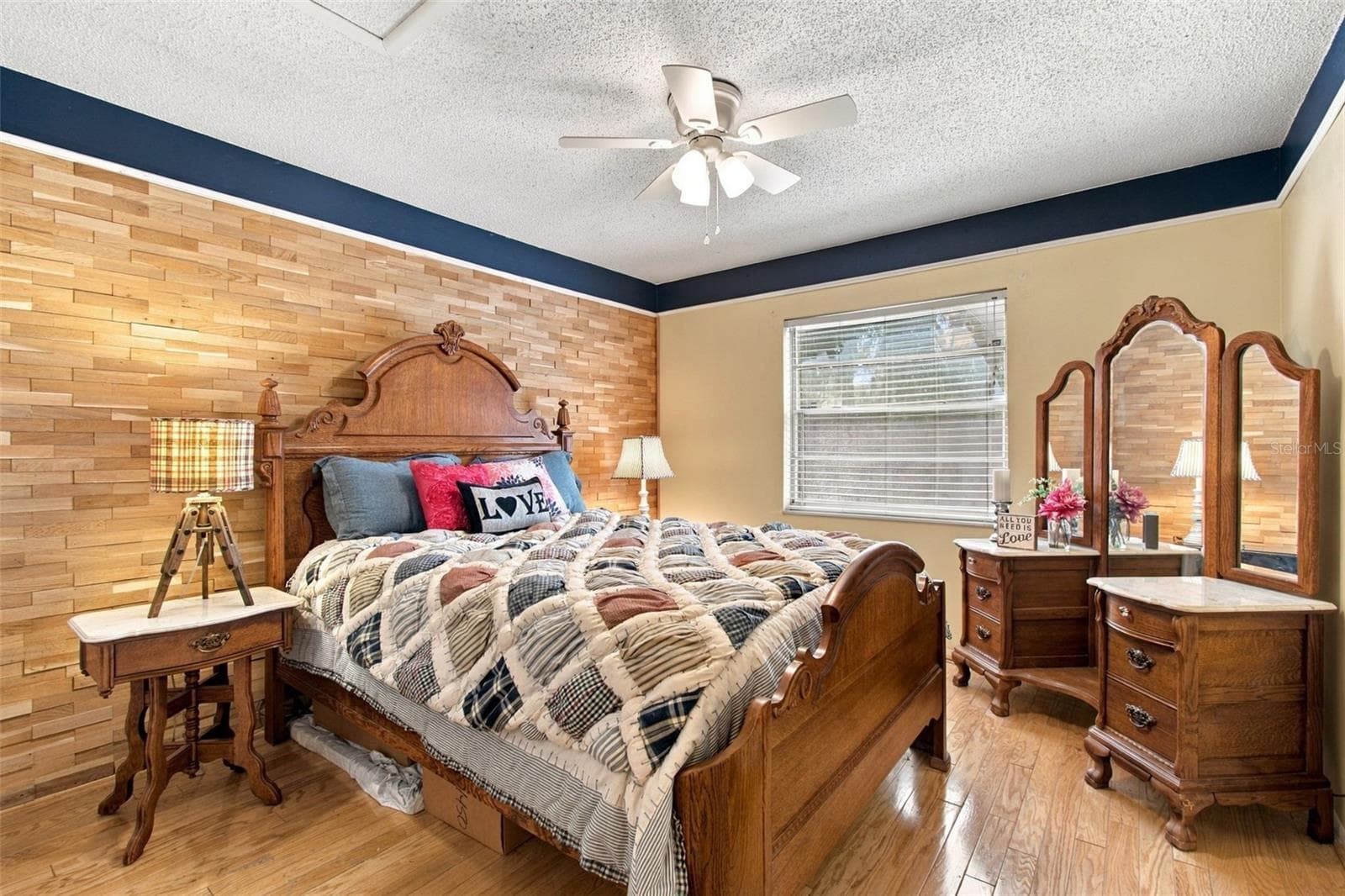 Your primary bedroom features a beautiful custom wood panel wall and wood trim. - 13020 LEVERINGTON ST, TAMPA