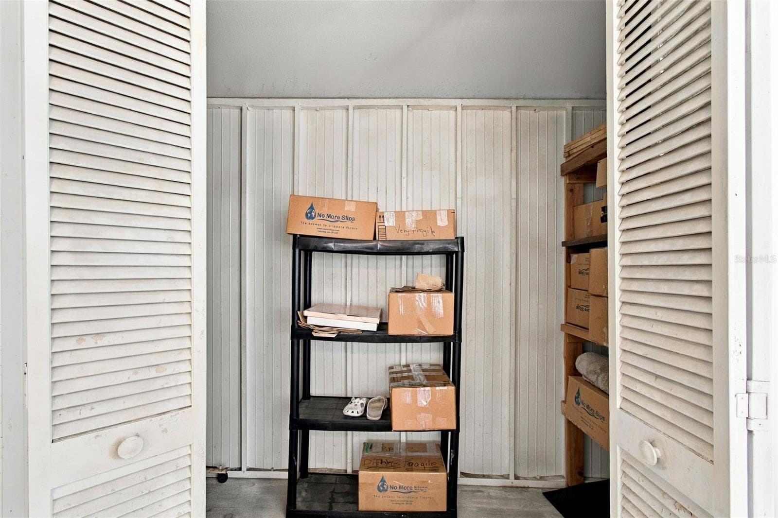 Your covered patio features a custom large storage closet. - 13020 LEVERINGTON ST, TAMPA