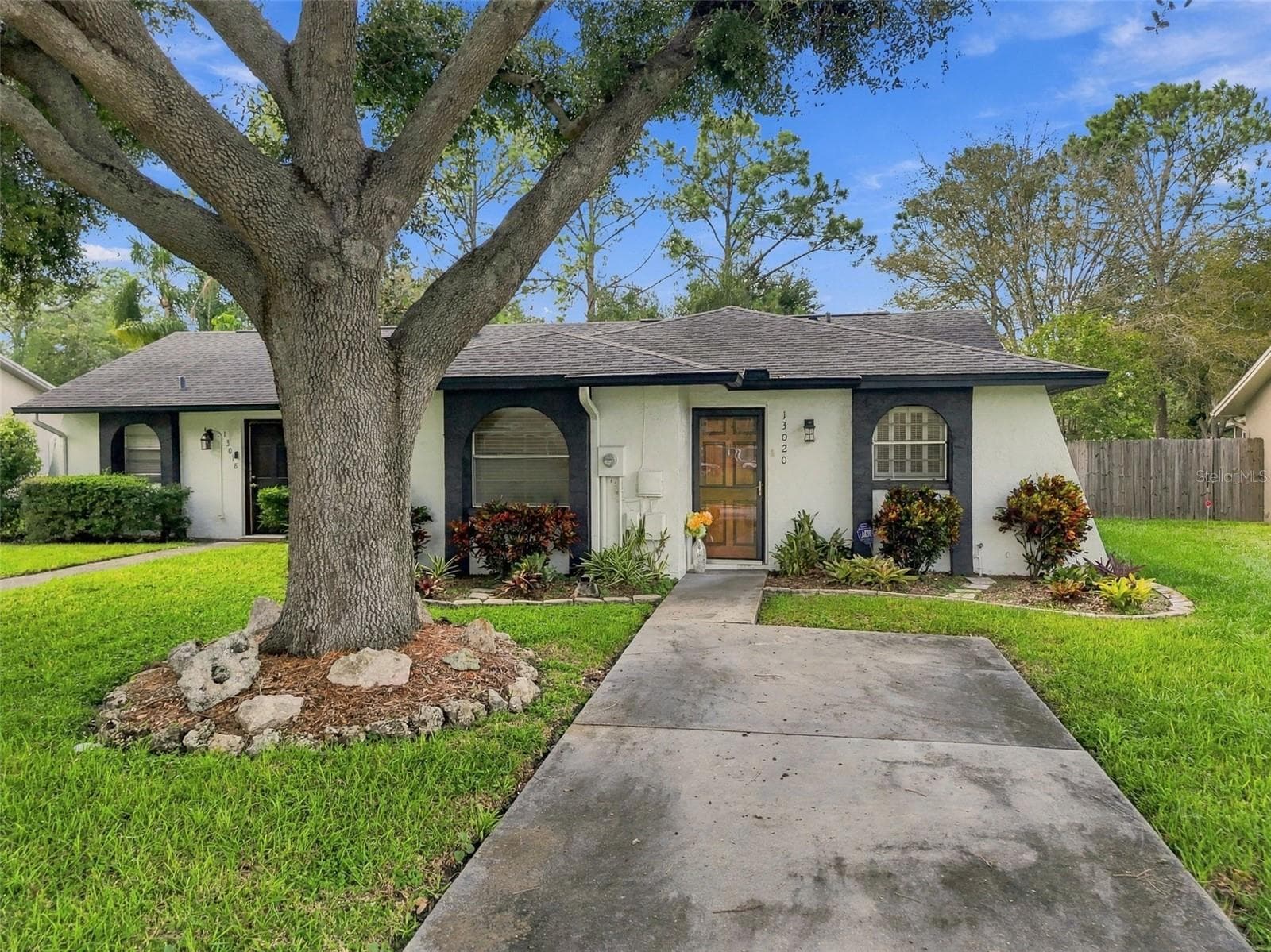 Your extra long driveway offers parking for two cars. - 13020 LEVERINGTON ST, TAMPA