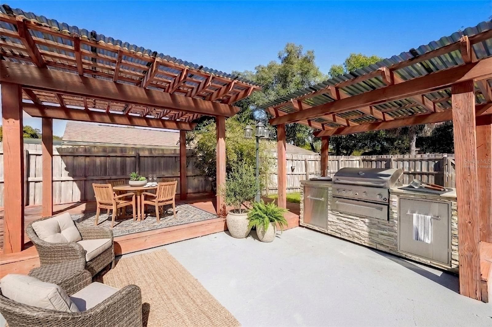 Outdoor pergola and grilling area - virtually staged - 954 NIBLICK DR, CASSELBERRY