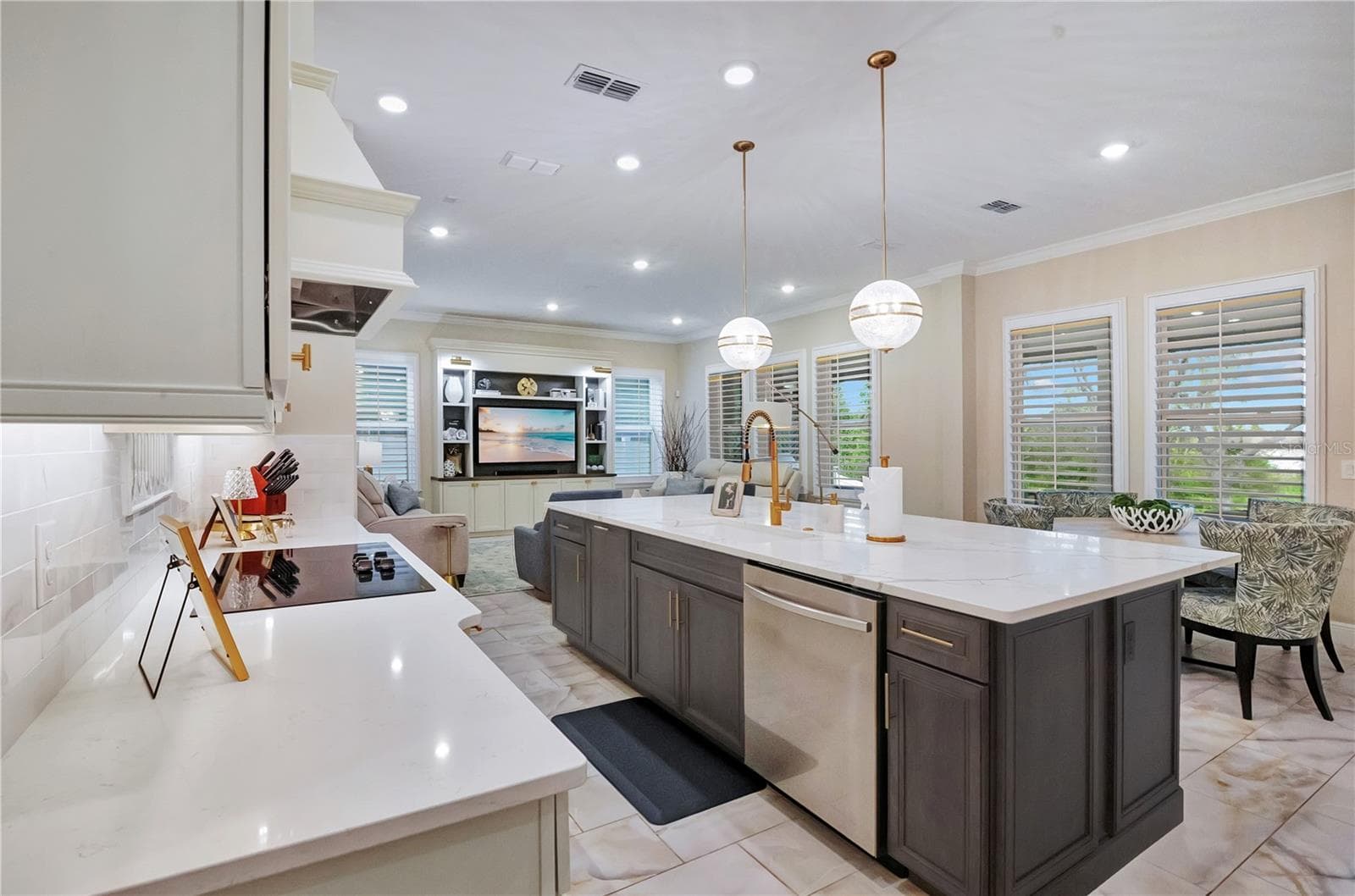 Expansive kitchen island features an undermount sink, built-in dishwasher and generous preparation space. - 17600 LAKE STAR RD, WINTER GARDEN