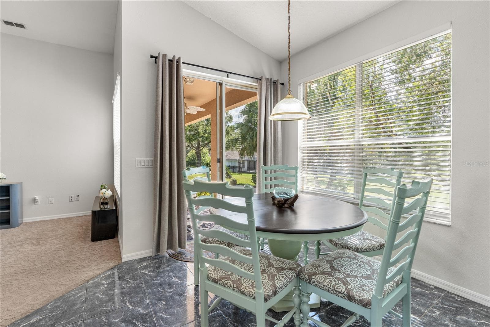 Breakfast area with sliding glass doors that lead to the covered porch - 725 TIGRIS LN, LAKE MARY