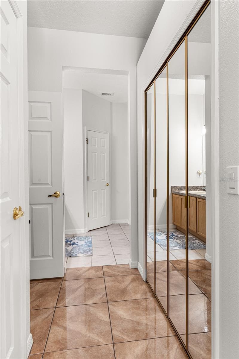 Primary bedroom walk-in closet is in-between the bedroom and the bathroom - 725 TIGRIS LN, LAKE MARY