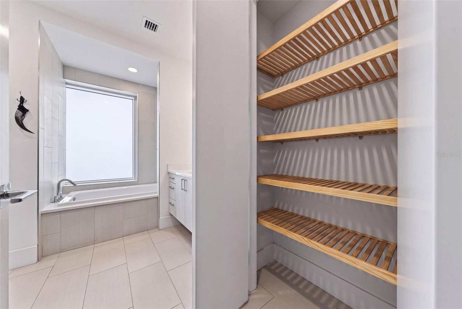 "His" Bath Linen/Toiletry Closet. Primary Ensuite - 540 N TAMIAMI TRL #1604, SARASOTA