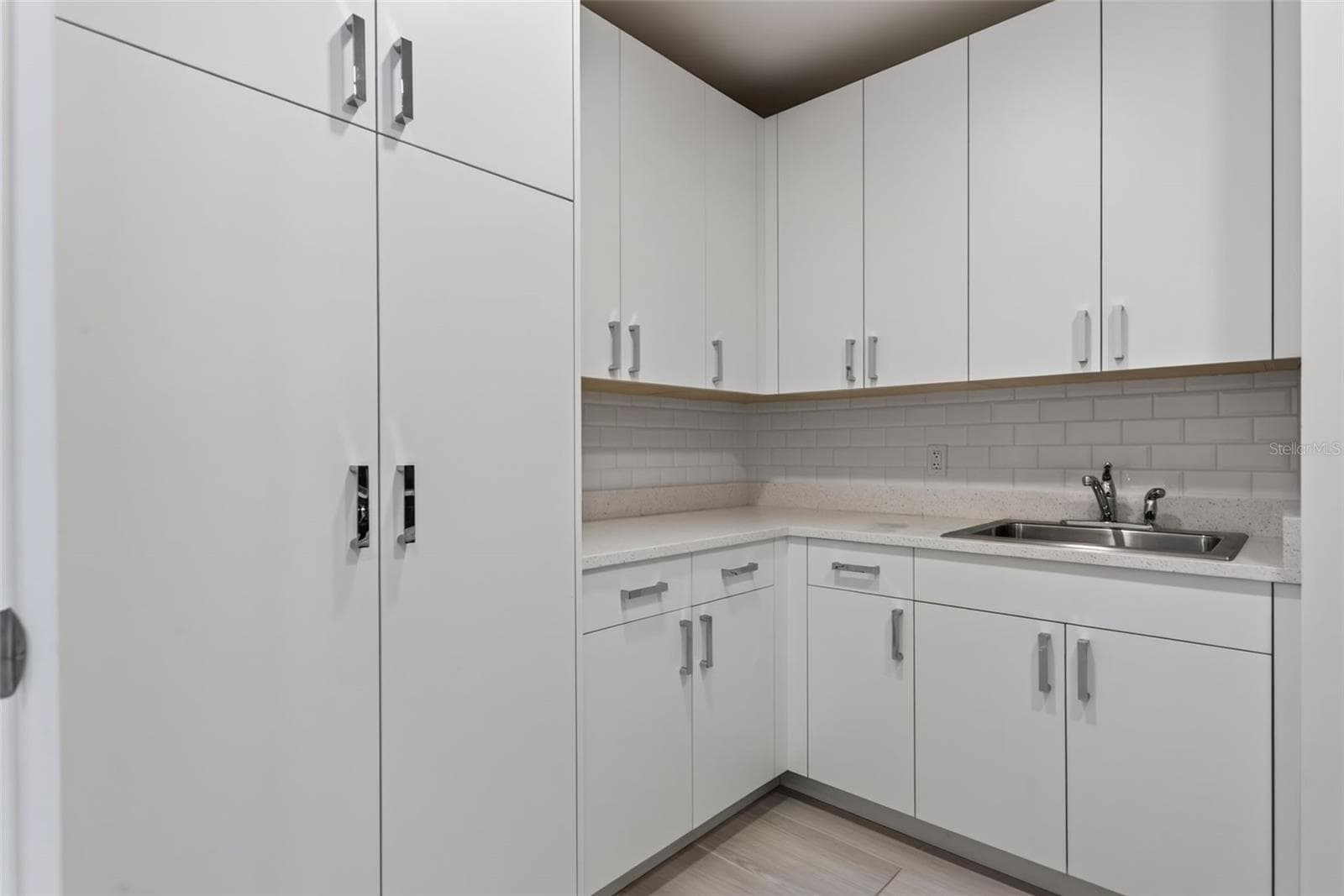 Walk-In Laundry Room with Ample Storage Cabinetry - 540 N TAMIAMI TRL #1604, SARASOTA