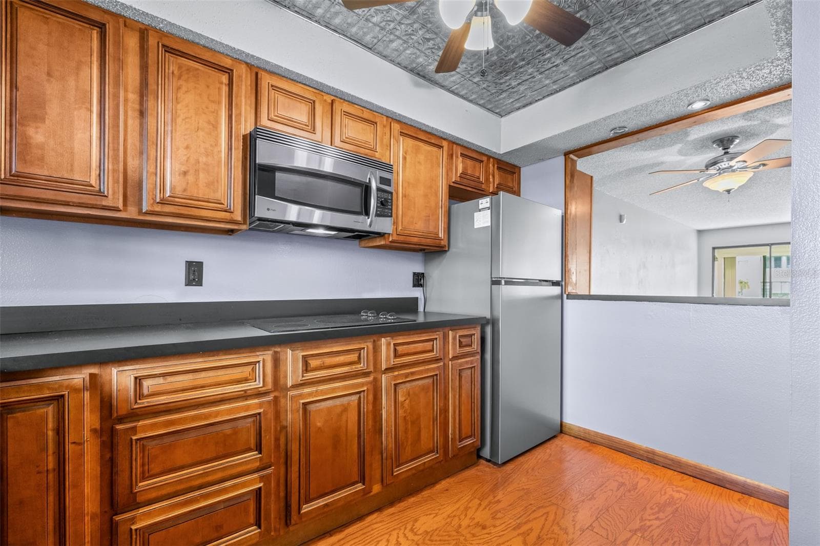 Brand new refrigerator with pass-through to dining/living area - 1750 BELLEAIR FOREST DR #A8, BELLEAIR