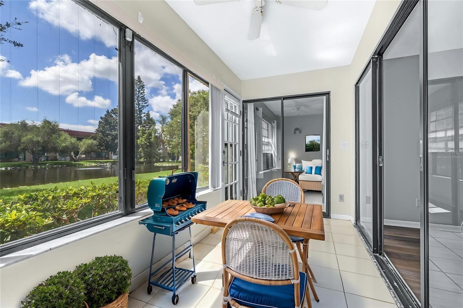 Virtually stagedFully enclosed Florida room overlooking duck pond - 1750 BELLEAIR FOREST DR #A8, BELLEAIR