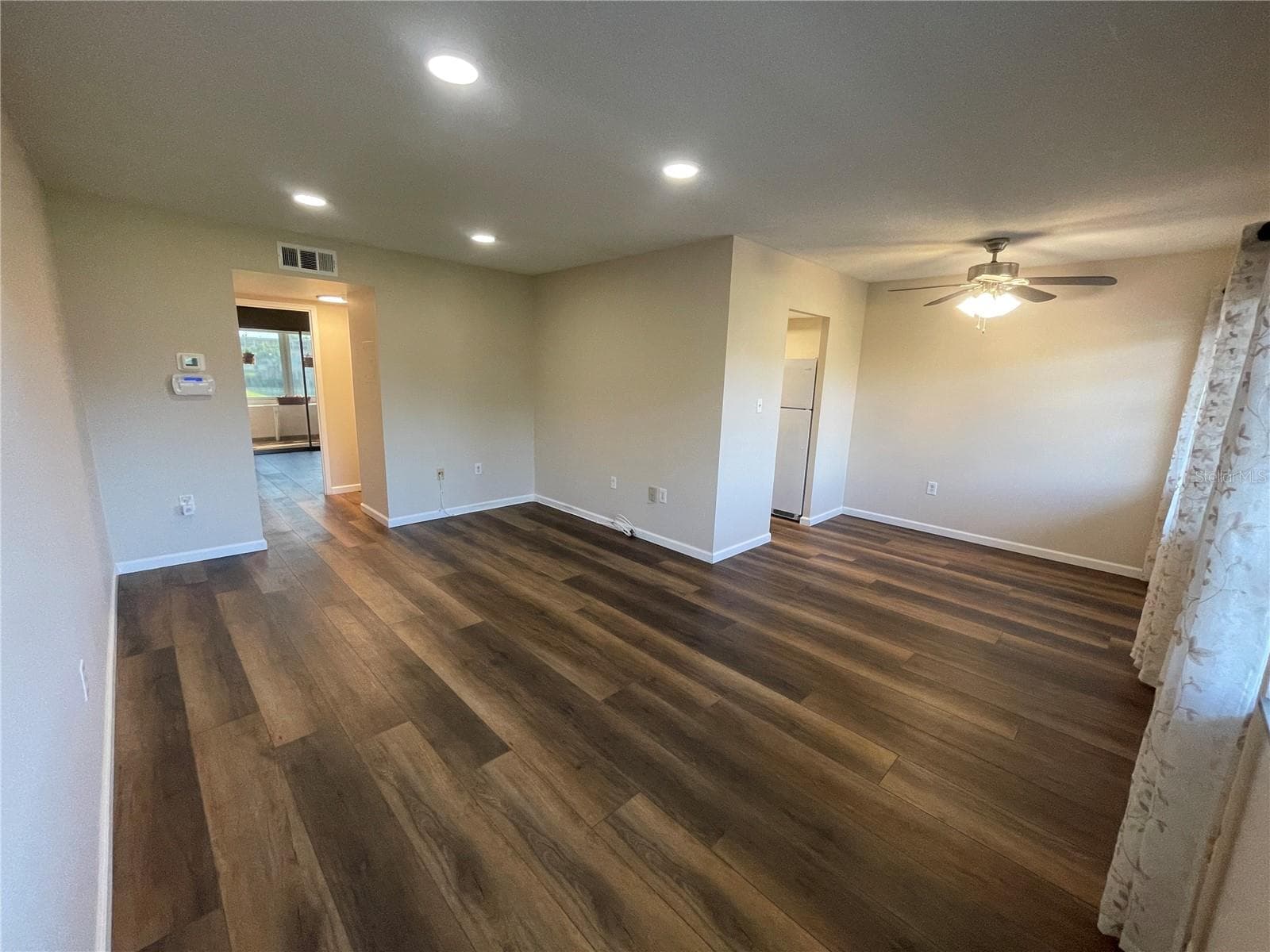 View from Living Room to Rest of Living Room and Dining Area - 8101 11TH ST N #217, ST PETERSBURG