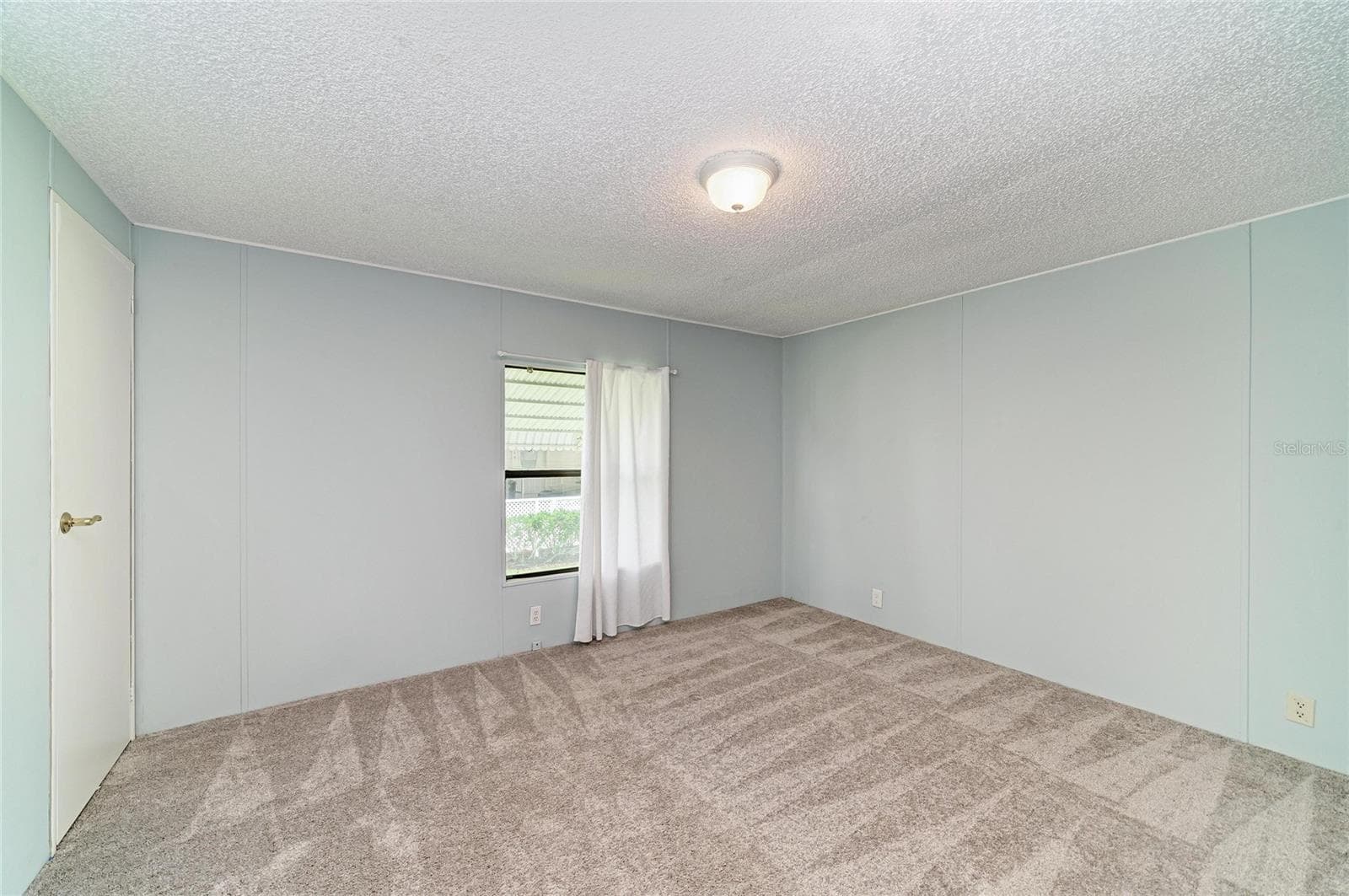 Bedroom 2 with newer carpet. Good size closet - 42 MEADOWLARK CIR, ELLENTON
