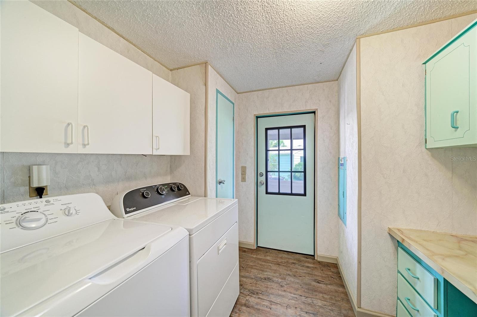 Inside laundrywith plenty of cabinets for storage and a good size countertop for folding or built in desk - 42 MEADOWLARK CIR, ELLENTON
