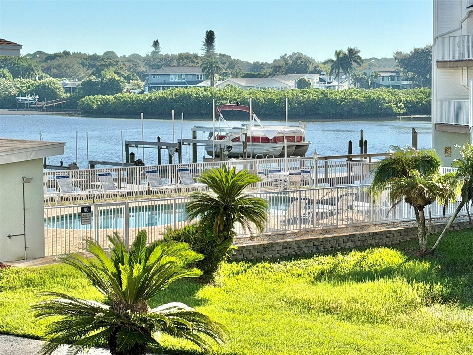 Pool and waterfront view from the Main Level Private Balcony. - 19201 VISTA LN #D2, INDIAN SHORES