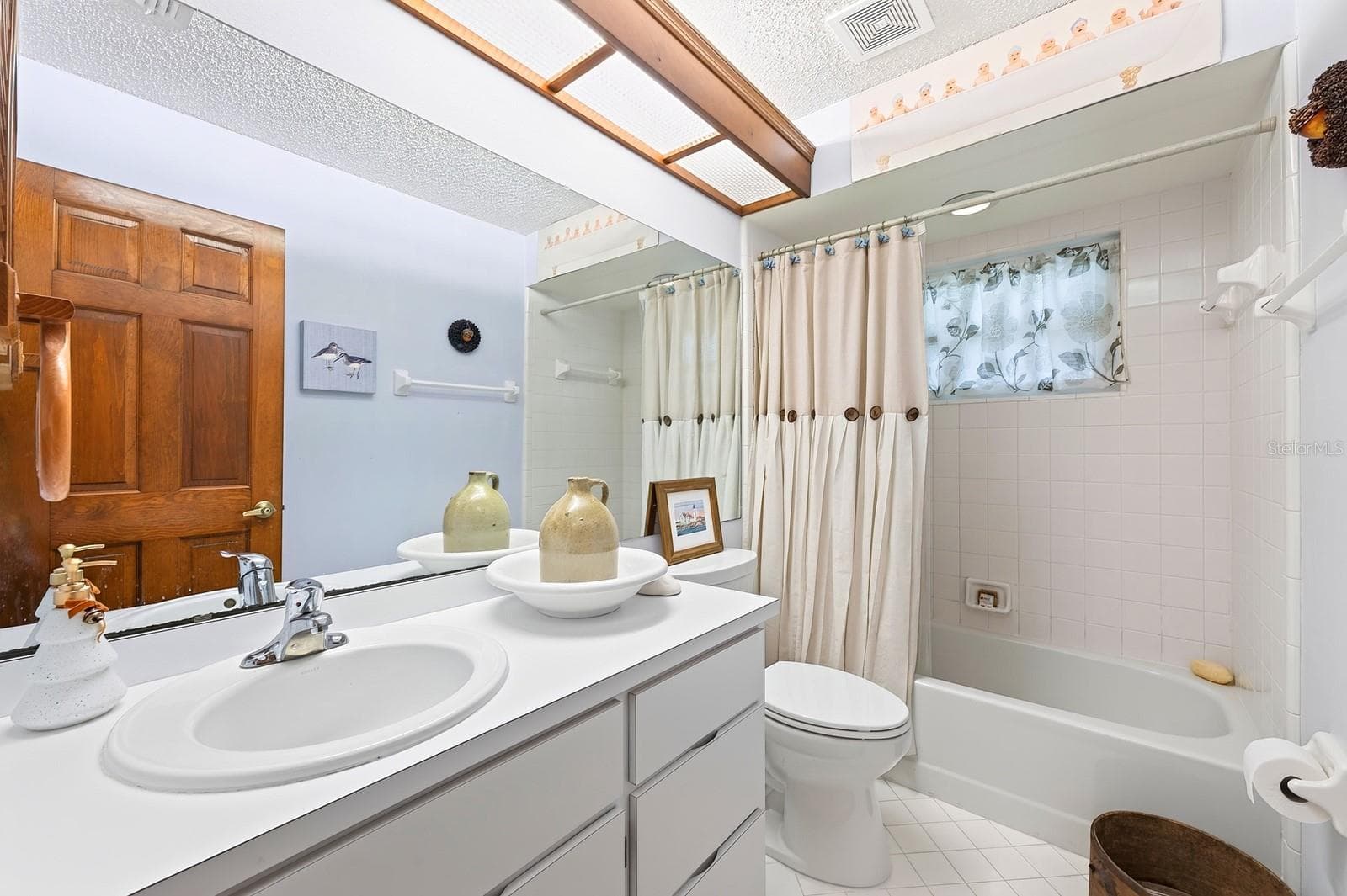 Both bathrooms have been refreshed with NEW WINDOWS AND TOILETS, adding another thoughtful touch to this WELL-CARED-FOR property. Bathroom 2 - 2163 NEWMARK DR, DELTONA