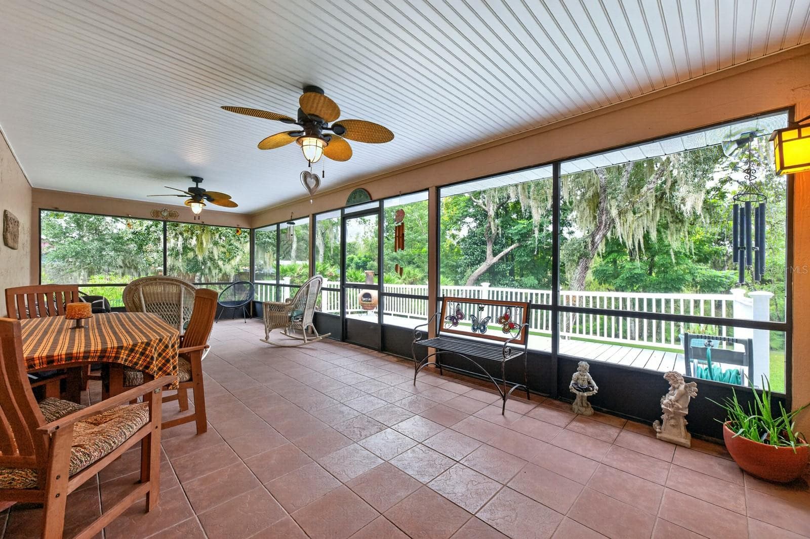 The FLORIDA ROOM is a standout feature, offering tile flooring, two modern ceiling fans, NEW SCREENS and a NEW CEILING. - 2163 NEWMARK DR, DELTONA