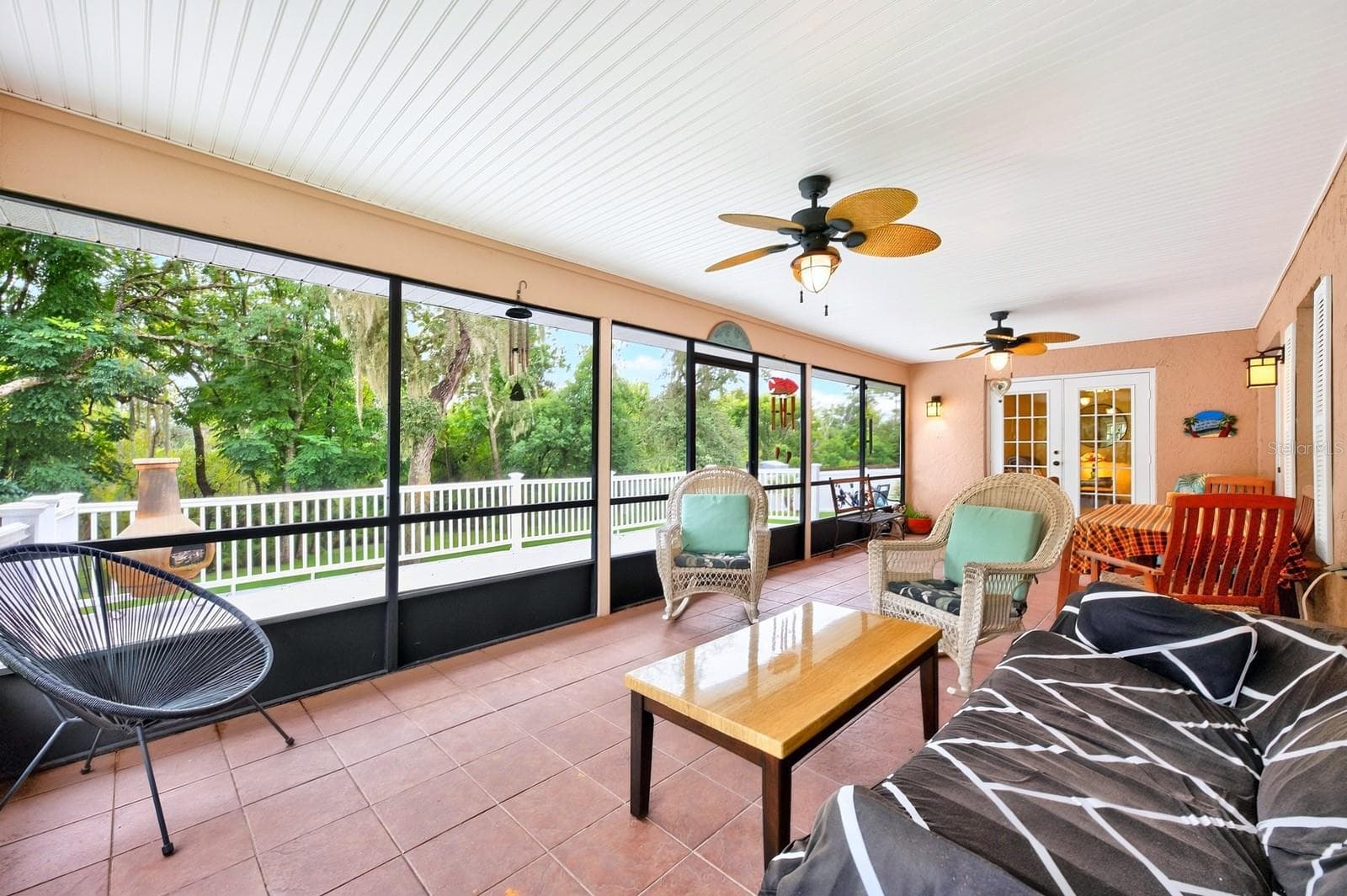 This versatile Florida Room is ideal for relaxing with a book, enjoying morning coffee, entertaining friends or simply taking in the view of the backyard. - 2163 NEWMARK DR, DELTONA