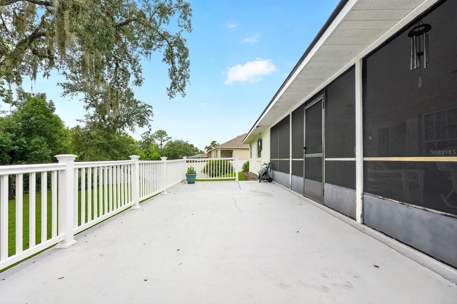 Step outside to the LARGE OPEN DECK overlooking the beautiful yard, where MATURE TREES create a lovely backdrop for outdoor enjoyment. - 2163 NEWMARK DR, DELTONA