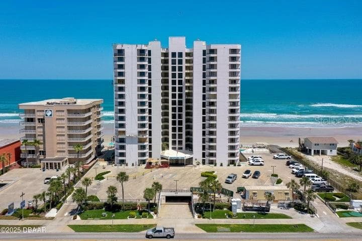 The building's clean façade and gated entrance welcome residents with manicured landscaping, ample parking, and ocean views from every level. - 3855 S ATLANTIC AVE #401, DAYTONA BEACH