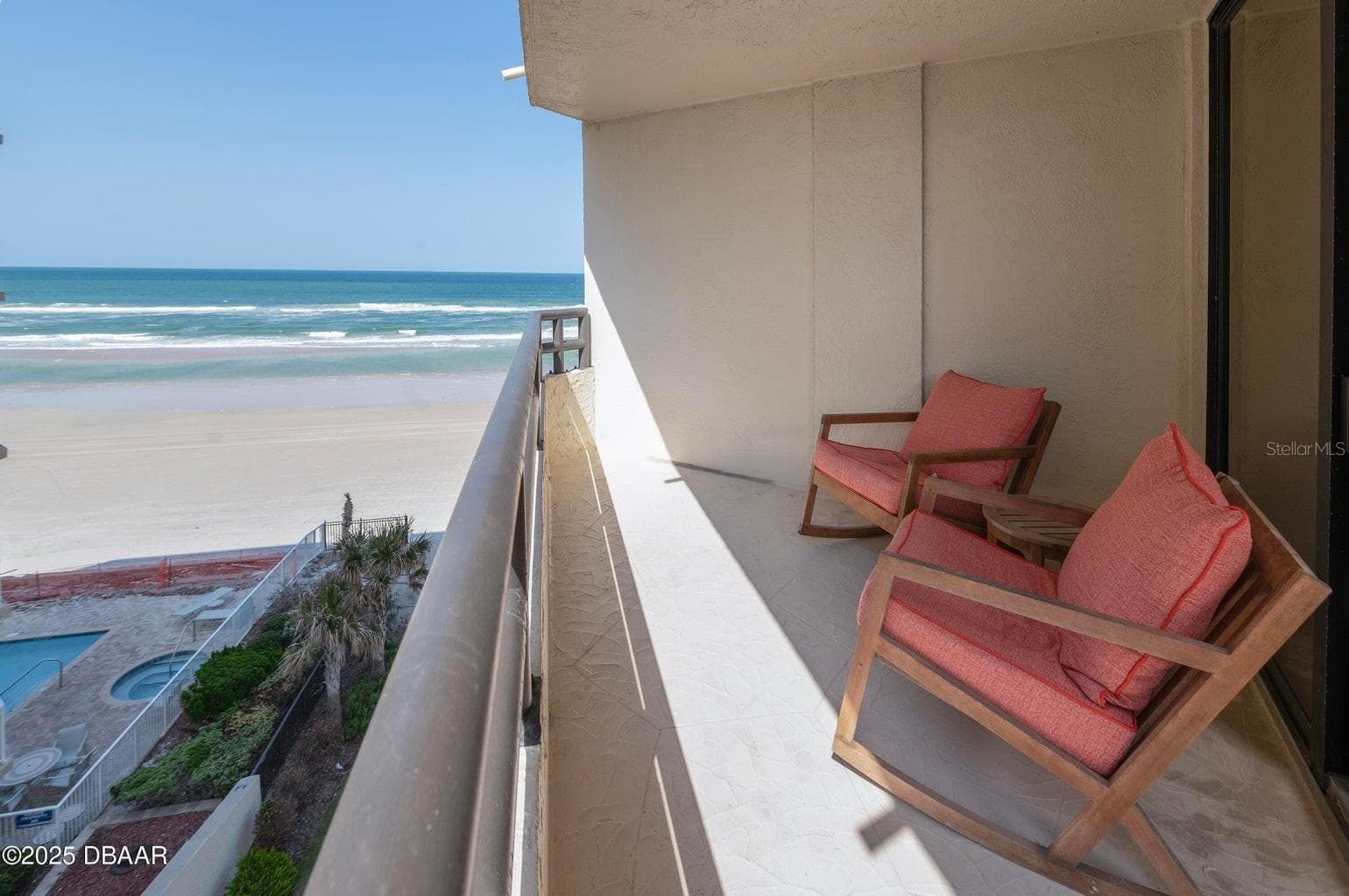 Ample balcony space with room for seating, overlooking the pool and beach for a true resort-style experience. - 3855 S ATLANTIC AVE #401, DAYTONA BEACH