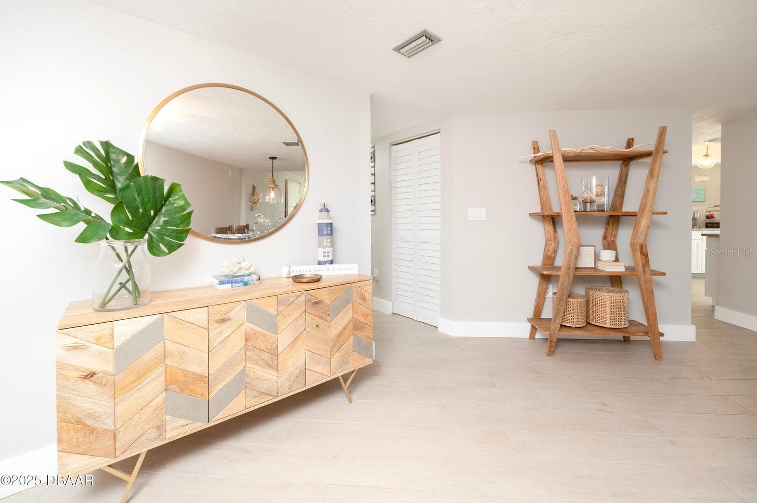 This bright, coastal-inspired entry features neutral tones, creating an inviting introduction to the residence. - 3855 S ATLANTIC AVE #401, DAYTONA BEACH