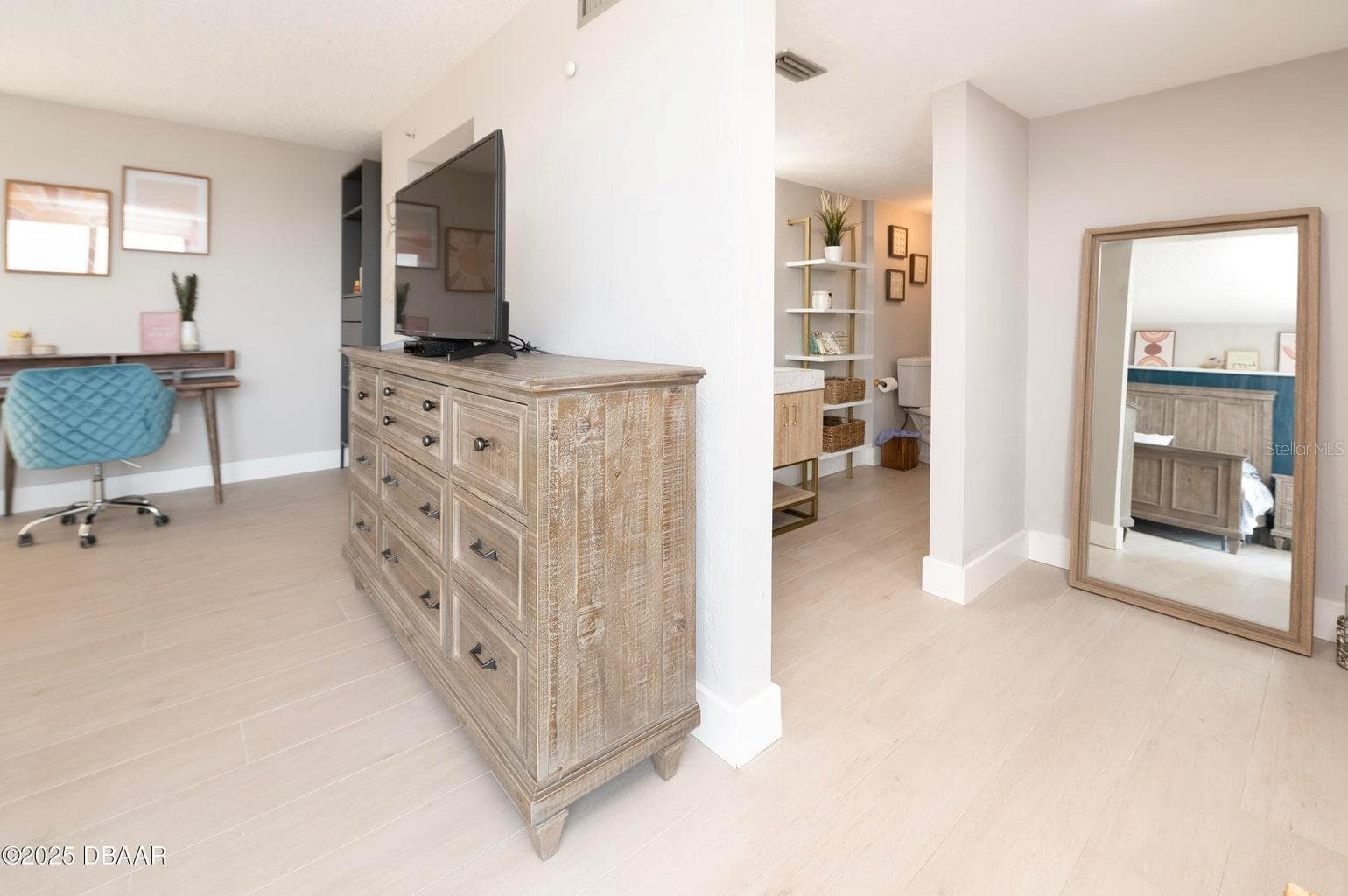The primary suite offers a spacious dressing area with room for additional furnishings and convenient access to the adjoining bathroom. - 3855 S ATLANTIC AVE #401, DAYTONA BEACH