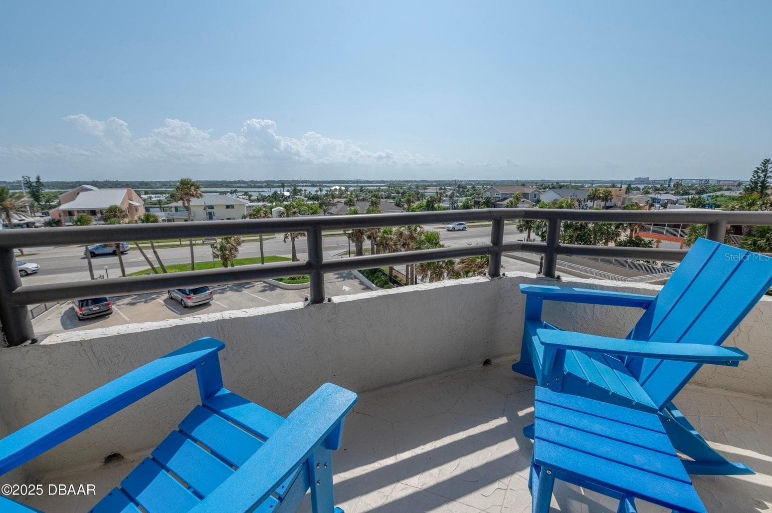 Relax on the private balcony overlooking the surrounding coastal neighborhood, with scenic inland views and comfortable space to enjoy morning coffee or evening breezes. - 3855 S ATLANTIC AVE #401, DAYTONA BEACH