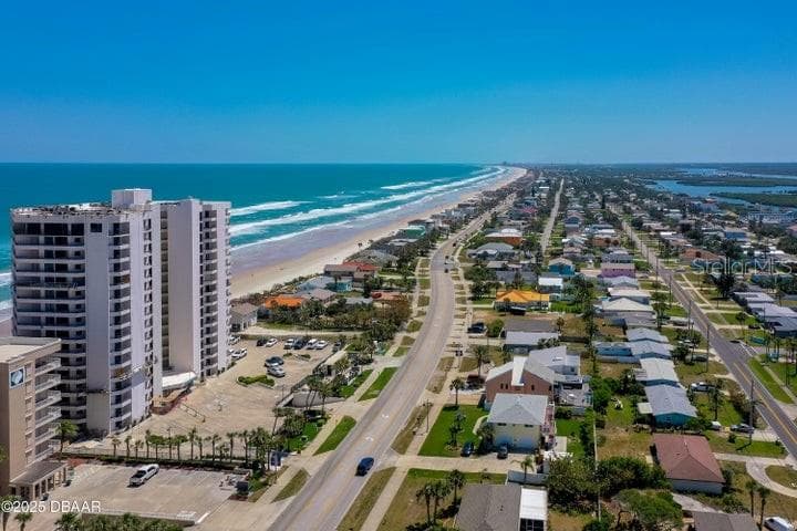Aerial perspective showcases the vibrant coastal neighborhood and scenic drive north, perfect for bike rides or leisurely strolls. - 3855 S ATLANTIC AVE #401, DAYTONA BEACH