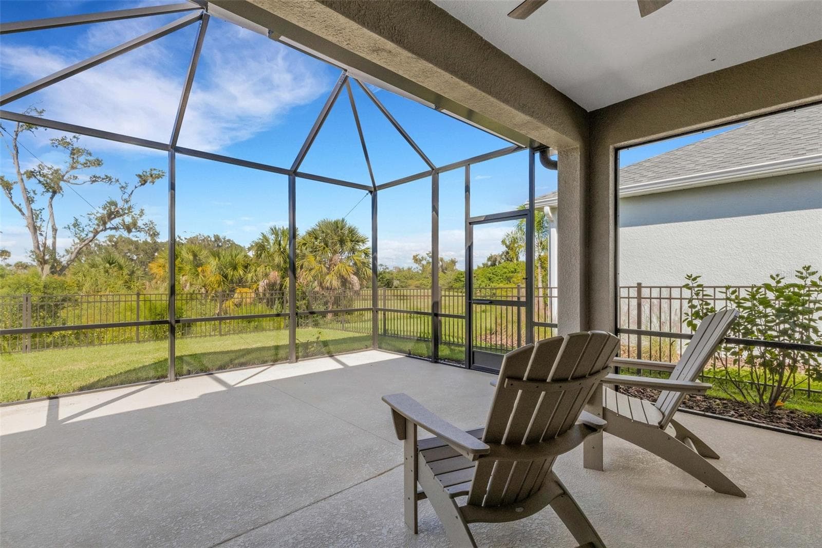 Relax in the screened outdoor living area with space for comfortable seating and easy access to the fenced backyard. - 10426 CROOKED CREEK CT, PARRISH