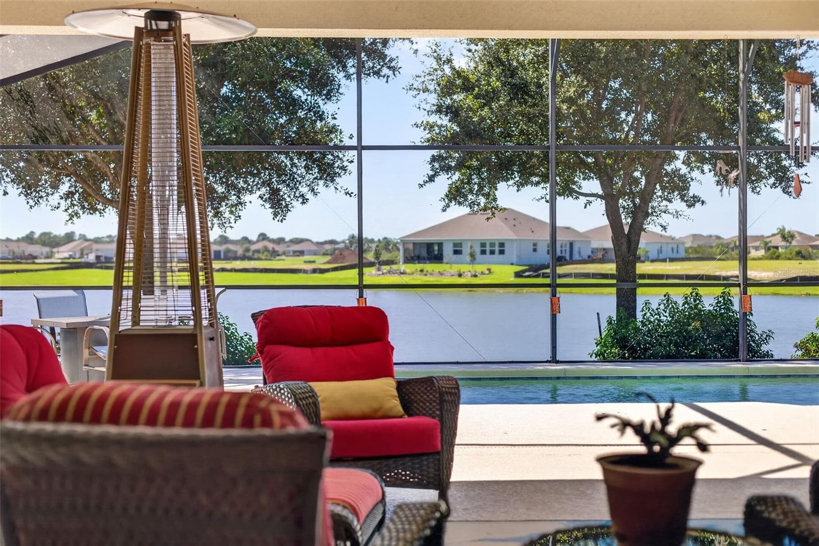 Take in breathtaking pool and lake views from your expansive, covered lanai—the ultimate setting for outdoor living and entertaining. - 2444 PAWTUCKET PASS, MOUNT DORA